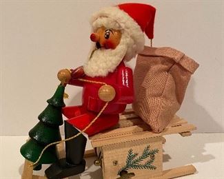 German made Steinbach Smoker of Santa on a sled and Reguge music box.  The sled moves forward as the music box plays.   
