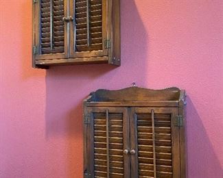 A pair of vintage American Colonial revival style wall mounted whatnot cabinets with louvered fronts.