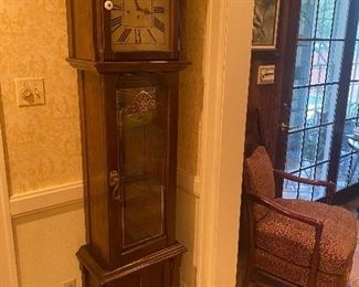 A combination clock and curio cabinet of the 1970s in the early American style popular at the time. 