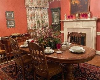 A vintage French Country style dining table and matching chairs, 2 arm (host & hostess) and four side chairs with rush seats.   The set comes with two leaves.