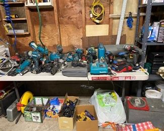 Many drills on table. Garage filled with all kinds of tools, Generator, grinder, many hand tools, spray paints, garden fertilizers, etc.