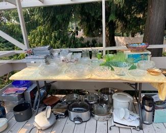 deck outside kitchen filled with all kinds of kitchen ware and glass, vases.