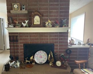 Porcelain figurines of birds on mantle.