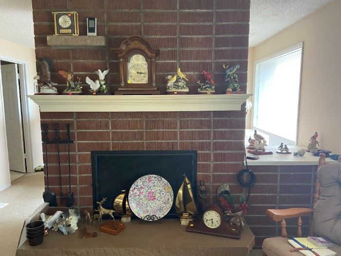Porcelain figurines of birds on mantle. 