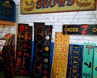 Carnival/circus vintage signs. Huge, metal "SHOWS" sign, wired for lights. Wooden over/under signs. Other various sets of wooden carnival game signs.