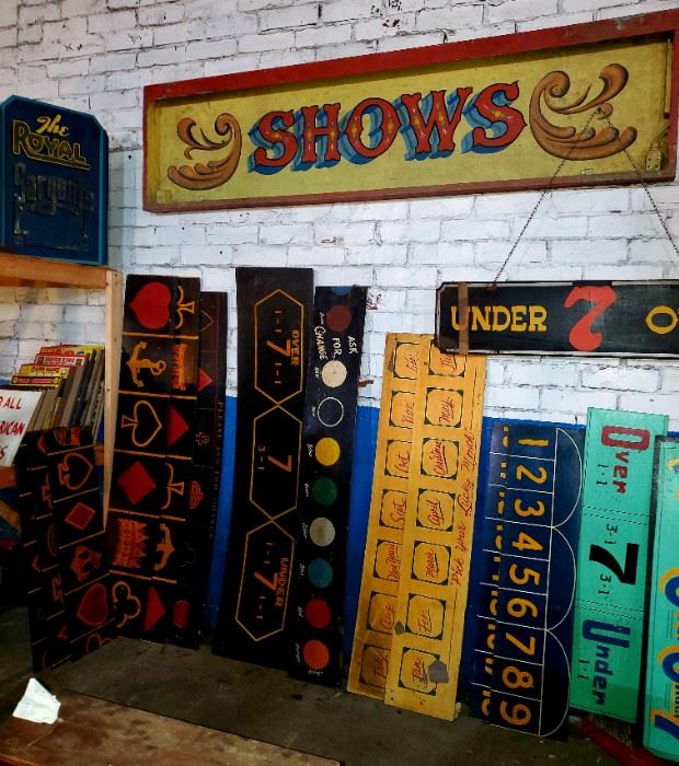 Carnival/circus vintage signs. Huge, metal "SHOWS" sign, wired for lights. Wooden over/under signs. Other various sets of wooden carnival game signs.