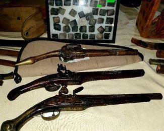Antique flint lock pistols (one rat tail) along with flints.