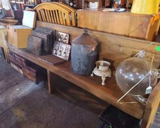 Wooden antique church pew, candy molds, enamel water jug, glass milk receiver jar, silver boxes.