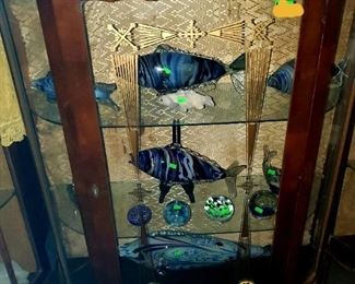 Small curved curio, hand blown glass fish, glass paper weights. 