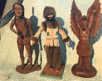 Carved wooden Indian (signed), carved Indian with eagle wings, and Alaskan man. 