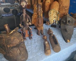 African wooden masks, fertility carvings, sculptures, and ceremonial wooden gongs. 