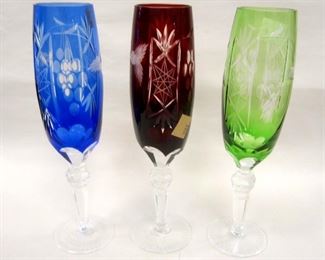 THREE BOHEMIAN CUT TO CLEAR GLASS FLUTES. 9" TALL. RED ONE DOES NOT STAND LEVEL