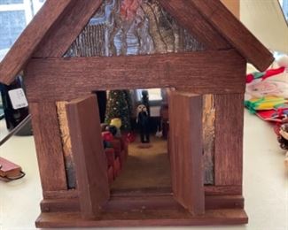 Lighted wooden church filled with people.