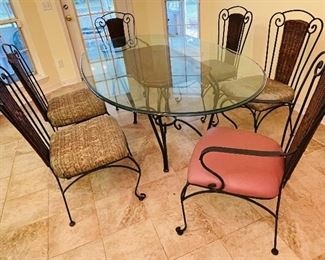 $275  •  #19  Glass oval top bistro dining table, wicker back metal  frame • 4 side chairs & 2 armchairs • 29high 82wide 46deep  • chairs 39 hi 21wide 21 deep