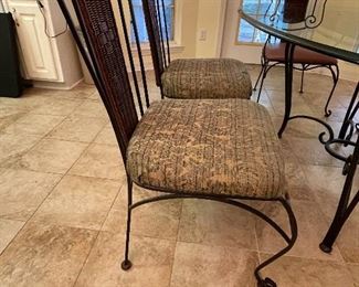 $275  •  #19  Glass oval top bistro dining table, wicker back metal  frame • 4 side chairs & 2 armchairs • 29high 82wide 46deep  • chairs 39 hi 21wide 21 deep