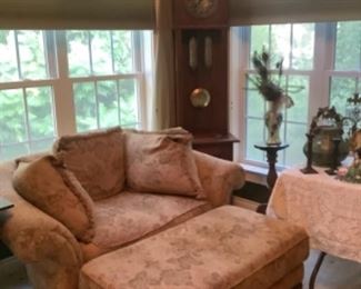 Cozy reading chair and very old grandfather clock