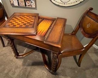 Mahogany game table featuring hand tooled leather top with a chess board and backgammon board below. This game table and chair set is available at Scully & Scully in New York.