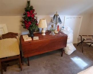antique table and vintage folding chairs, luggage stand