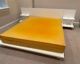 Modern, white lacquer Queen platform bed with built-in side tables and foam mattress. 