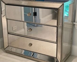 Mirrored three-drawer bureau. Some cracks in glass. Priced to sell! Measures 42" W x 18" D x 32" H.