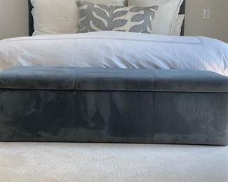 Blue suede upholstered storage bench. 