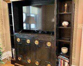 Custom Bausman & Company lighted cabinet with side sections and glass shelving