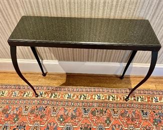Black granite console table with bowed steel lags