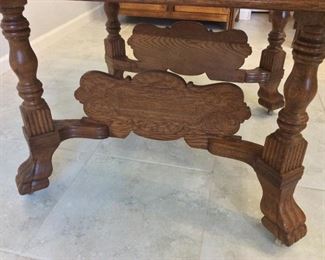 Antique Dining Room Table with 5 10" wide leaves and center support, footed legs with wooden wheels. Without the leaves the table measures 42" x 42", 29" H.