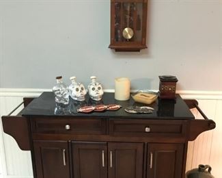 Rolling bar cart with faux stone top.