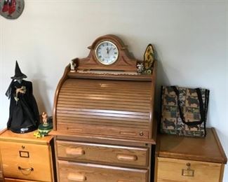 Oak two-drawer filing cabinets; Oak roll top storage cabinet with three drawers.
