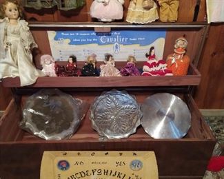 Two different cedar chest, vintage dolls and  Ouija board.