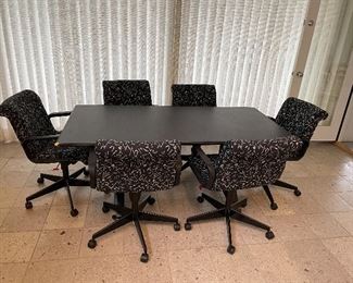 Retro 1980’s table and 8 rolling arm chairs.  Used as dining table.  Very comfortable