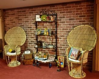 Two rattan Peacock chairs with a baker's rack and really cool collectibles