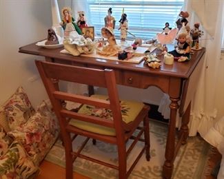 Vintage souvenir dolls on top a vintage maple dropleaf desk with antique oak chair