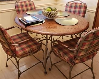 Wood and iron oval table and four armchairs