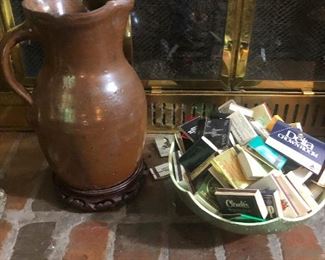 a pitcher of water ready to douse out spontaneous flame from bowl of matchbooks