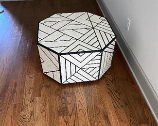 Bone Inlay Coffee Table by West Elm.   Bone Inlay Coffee Table marries a centuries-old tiling technique with modern geometric design. Its wood base is hand inlaid with black-and-white tiles to form intricate triangular patterns. Plus, we love how the natural sheen catches your eye from every angle.

30"diam. x 16.50"h.
Hand-inlaid tiles over engineered wood.
Natural bone and resin in Black + White.
Solid mango wood base.