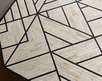 Bone Inlay Coffee Table by West Elm.   Bone Inlay Coffee Table marries a centuries-old tiling technique with modern geometric design. Its wood base is hand inlaid with black-and-white tiles to form intricate triangular patterns. Plus, we love how the natural sheen catches your eye from every angle.

30"diam. x 16.50"h.
Hand-inlaid tiles over engineered wood.
Natural bone and resin in Black + White.
Solid mango wood base.