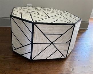 Bone Inlay Coffee Table by West Elm.   Bone Inlay Coffee Table marries a centuries-old tiling technique with modern geometric design. Its wood base is hand inlaid with black-and-white tiles to form intricate triangular patterns. Plus, we love how the natural sheen catches your eye from every angle.

30"diam. x 16.50"h.
Hand-inlaid tiles over engineered wood.
Natural bone and resin in Black + White.
Solid mango wood base.
