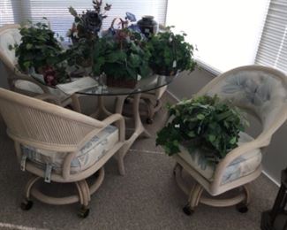 Glass round table patio set with 4 padded chairs.   Also many artificial greenery 
