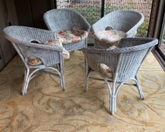 Four wicker chairs with cushions
