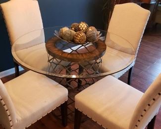 Glass top table and chairs
42 round
30 inches tall with 4 cream color 
Soft back button 