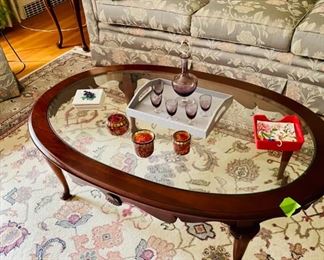 Glass top coffee table and the rug underneath it.