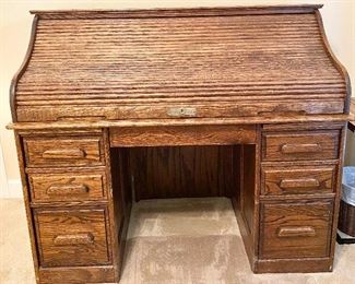 Solid Oak Roll Top Desk. Circa 1983. Mint condition with oak side panels. Quality workmanship! Measures 51 1/2" wide, 29" deep.