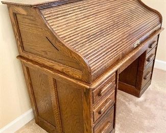 Solid Oak Roll Top Desk. Circa 1983. Mint condition with oak side panels. Quality workmanship! Measures 51 1/2" wide, 29" deep.