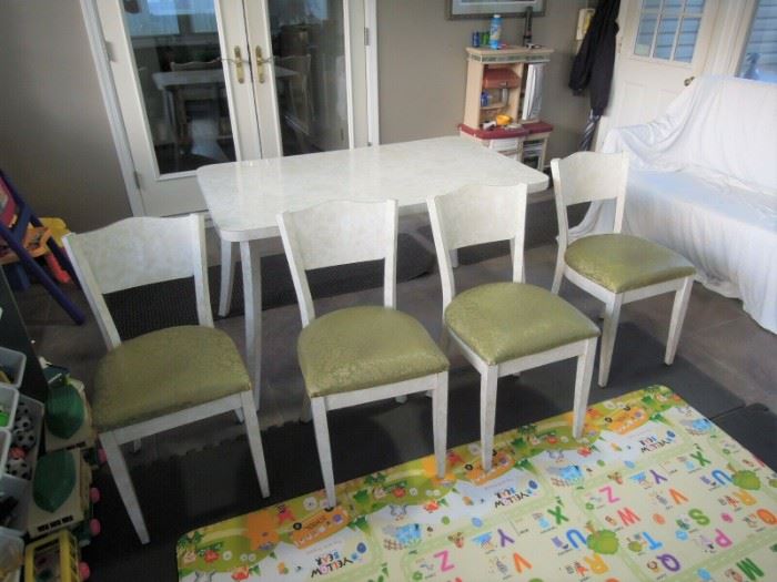 $400 obo -Very nice mid century modern formica kitchen table with center leaf and four chairs.  Table top , legs, chair backs and legs all covered in original formica. All pieces and cushions in very good to excellent original condition.  