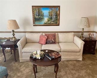 Berne Upholstered Sofa, Cherry Wood End Tables, Cherry Wood Round Coffee Table, Large Framed Canvas Painting, Lamps