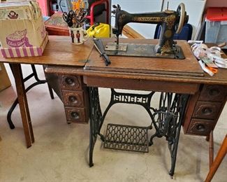 Antique Singer treadle sewing machine in cabinet