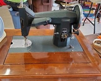 Antique Kenmore (heavy as all get out) sewing machine in sewing table.