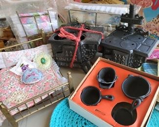 2 brass twin dollhouse beds with bedding, 1 queen brass dollhouse bed with bedding, 2 miniature Queen cast iron wood burning stoves, one set of cast iron stove accessories